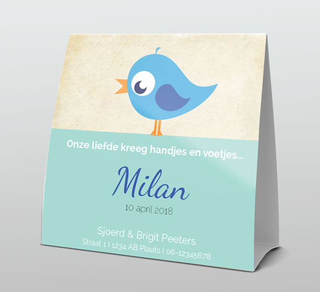 Blauw vogeltje in rond kader op oud papier Blauw vogeltje in rond kader op oud papier